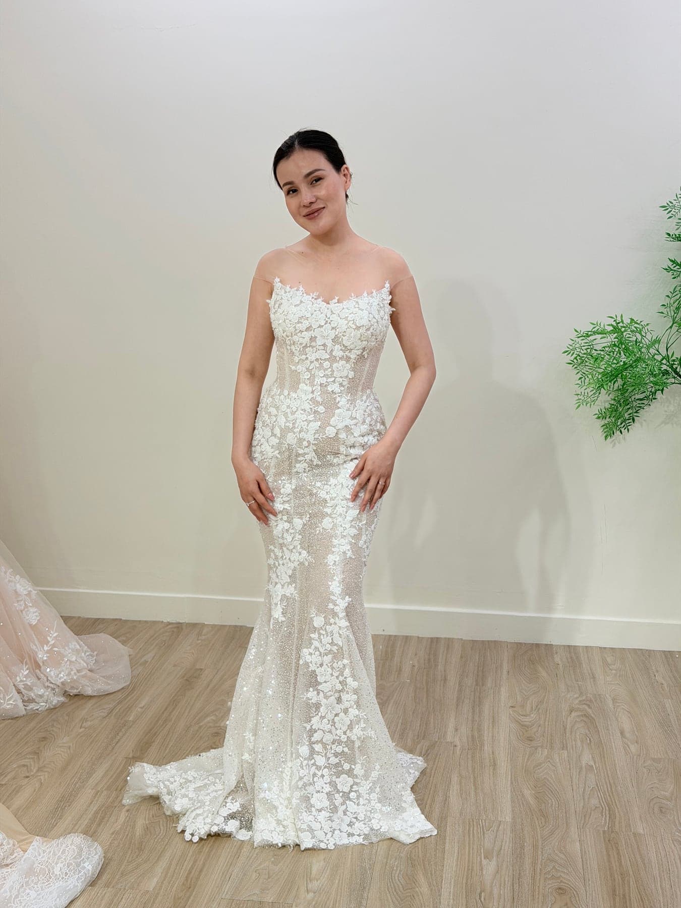 Bride in a floral lace sheath gown in the Saigon atelier